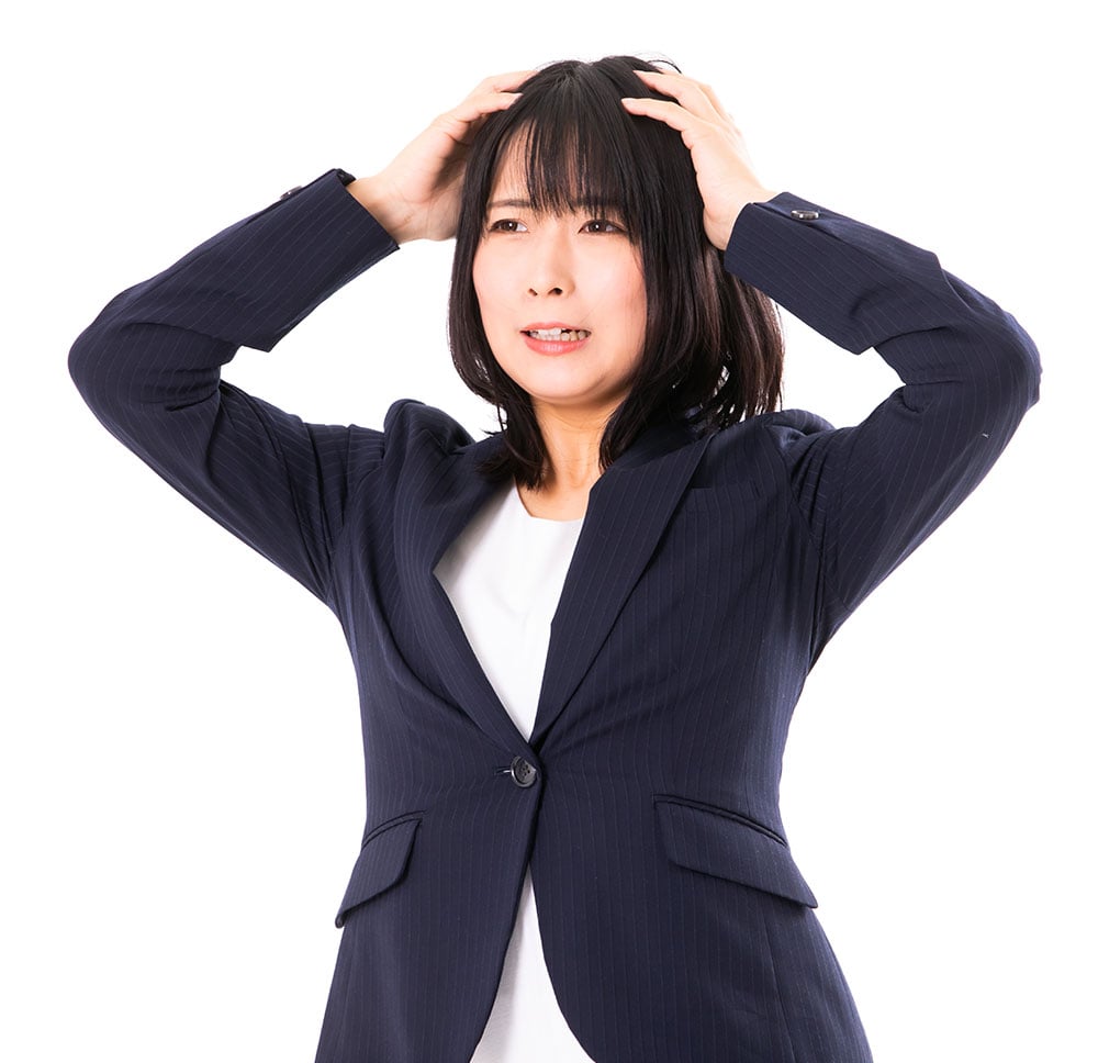 悩んで頭を抱える女性